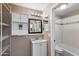 Cozy bathroom with classic fixtures including a white vanity, shelf storage, and tub at 2804 N Nebraska St, Chandler, AZ 85225