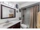Bathroom featuring dark wood vanity, floral accents, tile shower and rainfall shower head at 2804 N Nebraska St, Chandler, AZ 85225