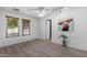 Bright bedroom with wood-look flooring, a ceiling fan, and two windows with wood-tone blinds at 2804 N Nebraska St, Chandler, AZ 85225