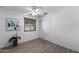 Clean bedroom with wood-look tile flooring, a ceiling fan, and a window with blinds at 2804 N Nebraska St, Chandler, AZ 85225