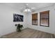 Neutral bedroom features wood-look flooring, a ceiling fan, and a window with wood-tone blinds at 2804 N Nebraska St, Chandler, AZ 85225