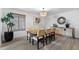 Well-lit dining room with table, six chairs, and a stylish sideboard with decorative mirror at 2804 N Nebraska St, Chandler, AZ 85225