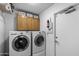 Modern laundry room with front load washer and dryer and above cabinet storage at 2804 N Nebraska St, Chandler, AZ 85225
