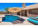 Backyard featuring a pool, shaded patio area, and low-maintenance desert landscaping at 30645 N 44Th St, Cave Creek, AZ 85331