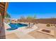 Backyard retreat featuring a sparkling pool, outdoor seating, and tranquil landscaping at 30645 N 44Th St, Cave Creek, AZ 85331