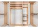 Bright walk-in closet with custom shelves and metal bars for optimal organization and storage at 30645 N 44Th St, Cave Creek, AZ 85331
