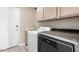 Functional laundry area equipped with cabinetry, a sink, and modern washer and dryer at 30645 N 44Th St, Cave Creek, AZ 85331
