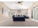Spacious bedroom with plush carpet, ceiling fan and a sliding glass door at 30645 N 44Th St, Cave Creek, AZ 85331