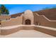 Charming outdoor fireplace with built-in seating for cozy desert evenings at 30645 N 44Th St, Cave Creek, AZ 85331