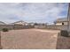 Expansive gravel backyard enclosed by a block fence providing a private outdoor space at 30996 W Osborn Rd, Buckeye, AZ 85396