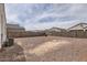 Big gravel backyard enclosed by block fencing; great for a customizable outdoor living area at 30996 W Osborn Rd, Buckeye, AZ 85396