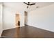 Bedroom with dark wood flooring, an overhead fan, and an attached bathroom at 30996 W Osborn Rd, Buckeye, AZ 85396