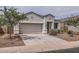 Charming single-story home featuring a two-car garage and desert landscaping at 30996 W Osborn Rd, Buckeye, AZ 85396