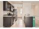 Open kitchen featuring dark cabinetry, granite countertops and stainless steel appliances at 30996 W Osborn Rd, Buckeye, AZ 85396