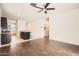 Open-concept living room features stylish dark wood flooring, bright lighting, and ceiling fan at 30996 W Osborn Rd, Buckeye, AZ 85396
