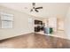 Bright open-concept living room with tile and dark wood flooring, connecting to the kitchen at 30996 W Osborn Rd, Buckeye, AZ 85396
