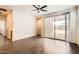 Open living area with dark wood flooring, leading to an outdoor patio through sliding glass doors at 30996 W Osborn Rd, Buckeye, AZ 85396