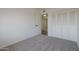 A spacious bedroom with neutral carpet and closet at 3208 N El Dorado Dr, Chandler, AZ 85224