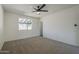 Cozy bedroom with neutral carpet, ceiling fan, and plenty of natural light at 3208 N El Dorado Dr, Chandler, AZ 85224