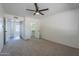 Carpeted bedroom features modern ceiling fan, and access to walk-in closet at 3208 N El Dorado Dr, Chandler, AZ 85224