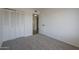 A bedroom with a closet, neutral carpet, and light walls at 3208 N El Dorado Dr, Chandler, AZ 85224