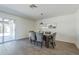 Bright dining room with wood-look tile flooring, stylish light fixture and access to patio at 3208 N El Dorado Dr, Chandler, AZ 85224