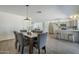 Open-concept dining area with wood-look tile flooring and direct access to the kitchen at 3208 N El Dorado Dr, Chandler, AZ 85224