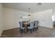 Dining room featuring wood-look tile flooring, a rustic wood table, and lots of natural light at 3208 N El Dorado Dr, Chandler, AZ 85224