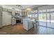 Updated kitchen features modern appliances, island with seating, and sliding glass door to patio at 3208 N El Dorado Dr, Chandler, AZ 85224