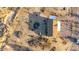 Aerial view of a one-story house, revealing its roof and the surrounding desert landscape at 3349 N Ralston Rd, Maricopa, AZ 85139