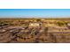 Aerial view of a quaint home with a car parked nearby amidst a desert landscape at 3349 N Ralston Rd, Maricopa, AZ 85139