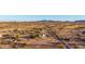 A charming desert community is captured from above with long dirt roads and distant mountains at 3349 N Ralston Rd, Maricopa, AZ 85139