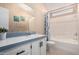 Bathroom features a sink with white cabinets and a bathtub with a colorful shower curtain at 3349 N Ralston Rd, Maricopa, AZ 85139