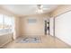 Neutral bedroom featuring tile flooring, a ceiling fan, and a large window at 3349 N Ralston Rd, Maricopa, AZ 85139