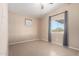 Small bedroom with tile flooring, a window with curtains, and neutral paint at 3349 N Ralston Rd, Maricopa, AZ 85139