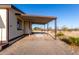 A porte-cochere is attached to the side of this one-story home with desert landscaping at 3349 N Ralston Rd, Maricopa, AZ 85139