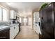 Modern kitchen featuring white cabinets, black appliances, and mosaic tile backsplash at 3349 N Ralston Rd, Maricopa, AZ 85139