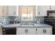 Well-lit kitchen boasting a stainless steel sink, mosaic backsplash, and scenic window view at 3349 N Ralston Rd, Maricopa, AZ 85139