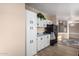 Kitchen featuring white cabinets, black appliances, and hardwood floors at 3349 N Ralston Rd, Maricopa, AZ 85139