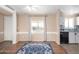 Open concept living area with hard wood floors, neutral paint, and view to kitchen at 3349 N Ralston Rd, Maricopa, AZ 85139
