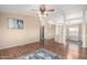 An open-concept living room with hardwood floors, neutral walls, a ceiling fan and adjoined spaces at 3349 N Ralston Rd, Maricopa, AZ 85139