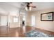 Inviting living room with wood floors, neutral walls, ceiling fan and seamless transition into adjoining rooms at 3349 N Ralston Rd, Maricopa, AZ 85139