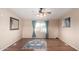 Living room featuring wood floors, a blue rug, and a ceiling fan, creating a warm and inviting space at 3349 N Ralston Rd, Maricopa, AZ 85139