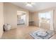 Bright main bedroom with neutral walls, tile flooring, and an en-suite bathroom at 3349 N Ralston Rd, Maricopa, AZ 85139