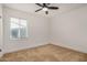 Neutral carpeted bedroom with ceiling fan, recessed lighting, and a bright window at 3441 E Taylor St, Phoenix, AZ 85008