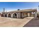 Charming home exterior features arched entryways, a covered carport, and a spacious front yard at 3441 E Taylor St, Phoenix, AZ 85008