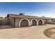 Charming home exterior features arched entryways, a covered carport, and a spacious front yard at 3441 E Taylor St, Phoenix, AZ 85008