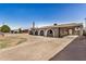 Charming home exterior features arched entryways, a covered carport, and a spacious front yard at 3441 E Taylor St, Phoenix, AZ 85008