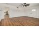 Open living room featuring new wood floors, fresh white paint, and view into the modern kitchen at 3441 E Taylor St, Phoenix, AZ 85008