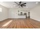 Bright open-concept living room with wood floors flows into a modern kitchen at 3441 E Taylor St, Phoenix, AZ 85008